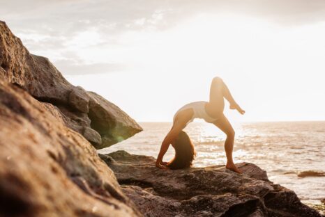 Lady Doing Yoga On The Beach