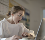 Shocked woman looking at laptop screen