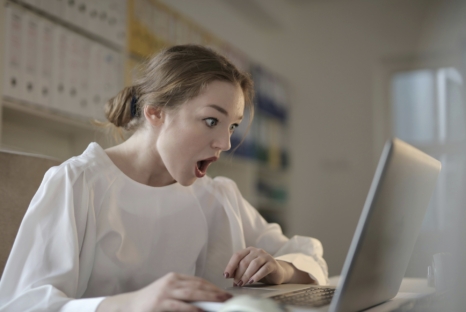 Shocked woman looking at laptop screen